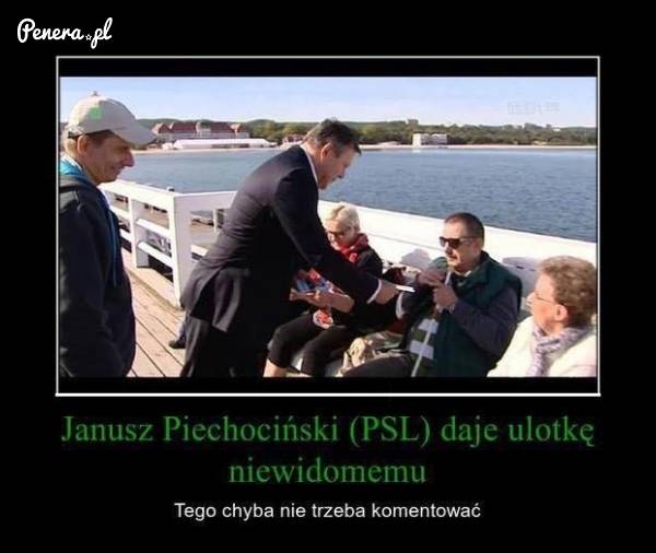 Piechociński wręcza ulotkę niewidomemu